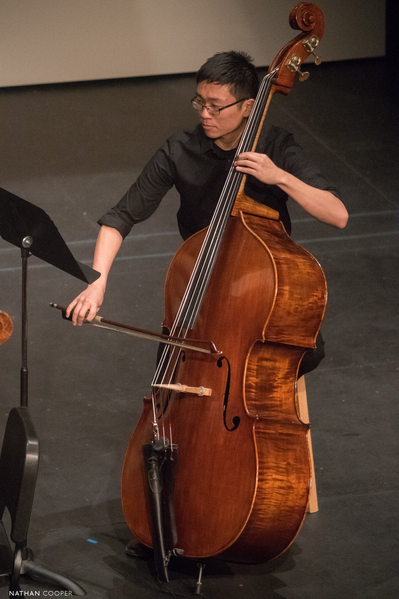 Photo of Tommy Wu playing bass