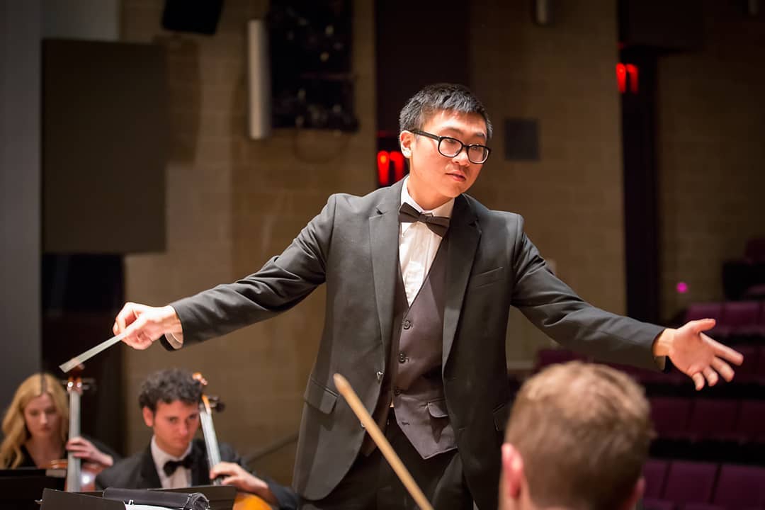 Image of Tommy Wu conducting.